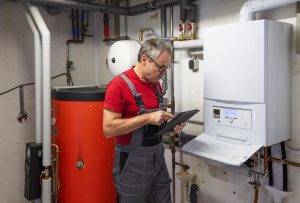 Plumber looking at a tankless water heater